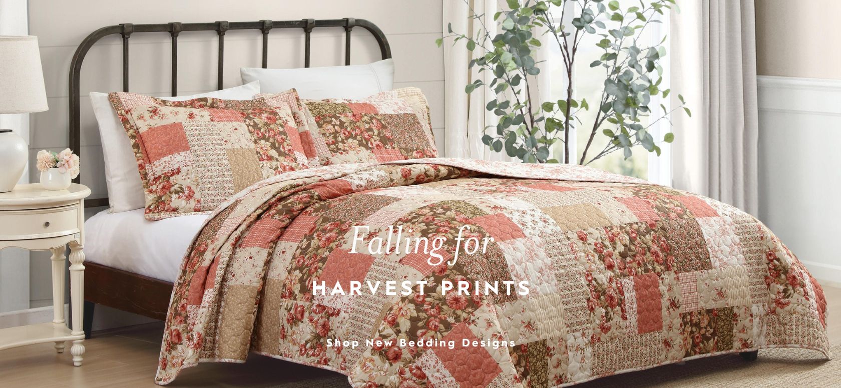 Henrietta Quilt Set on a bed with a large window in background.