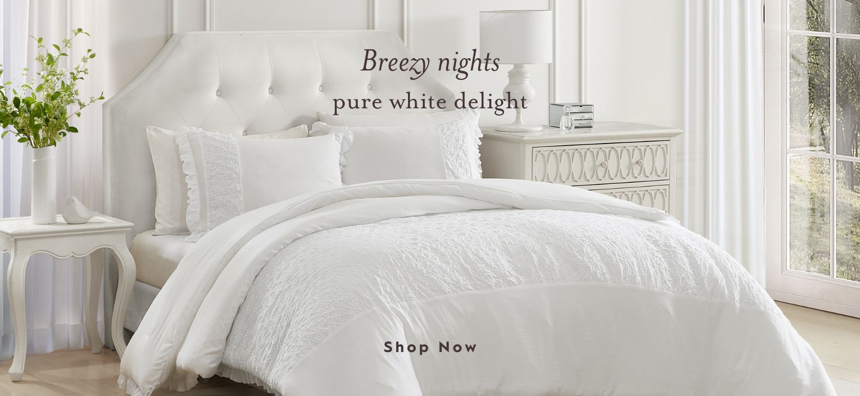 Eyelet Ruffle Microfiber White Comforter Set on a bed in a bedroom.