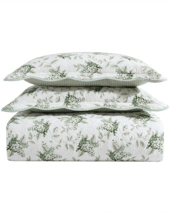 Portland Floral Green Cotton Reversible Quilt Set stacked against white drop